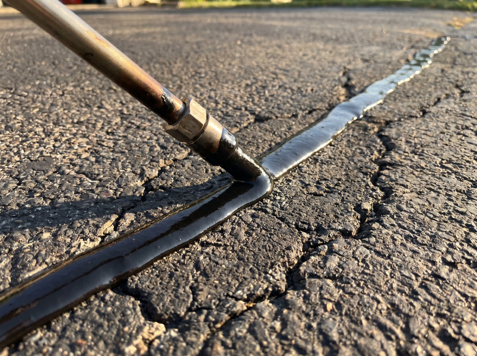 Hot rubber crack sealant filling a routed crack